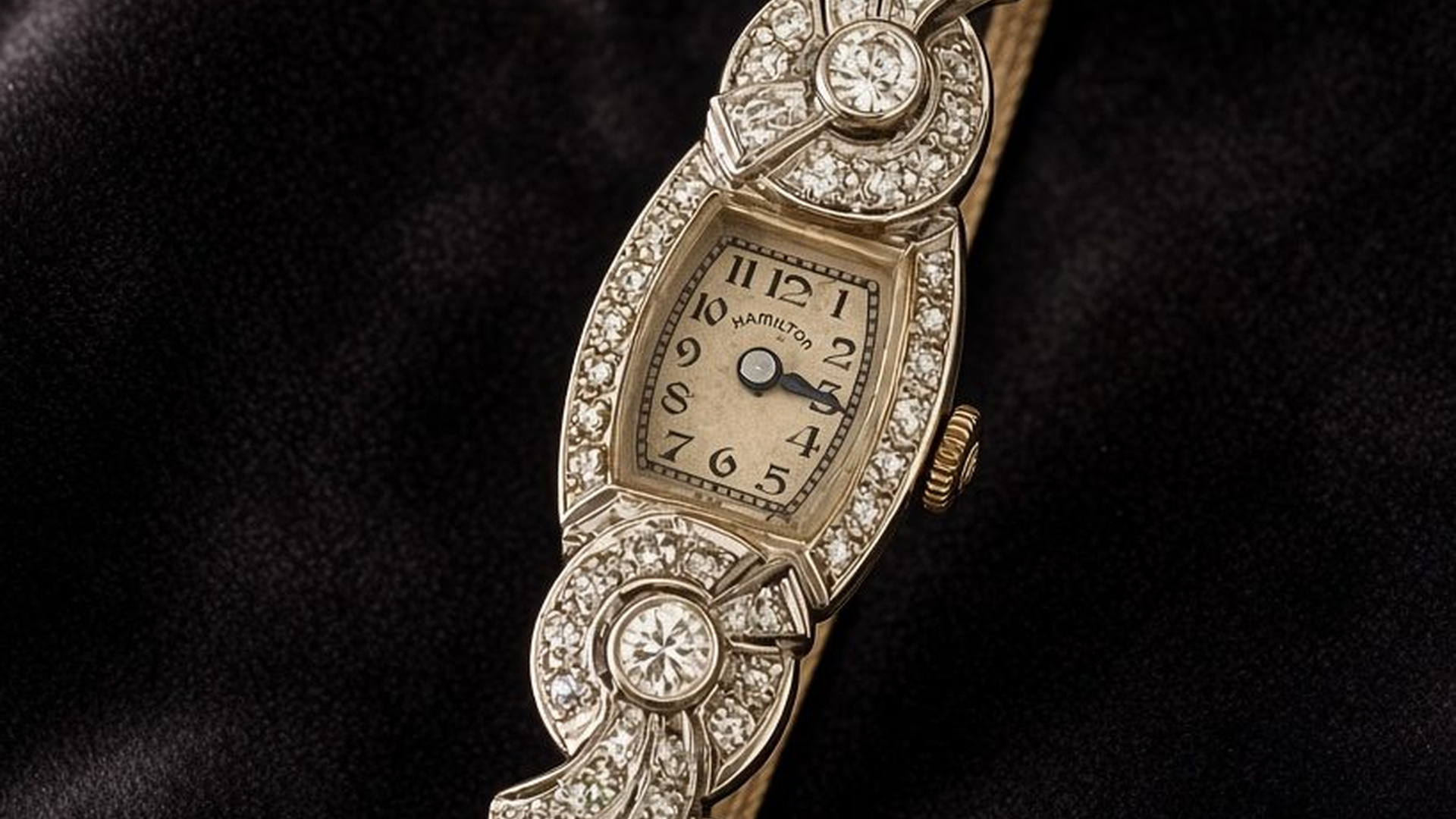 Hamilton cocktail watch and olive stone ring on black velvet